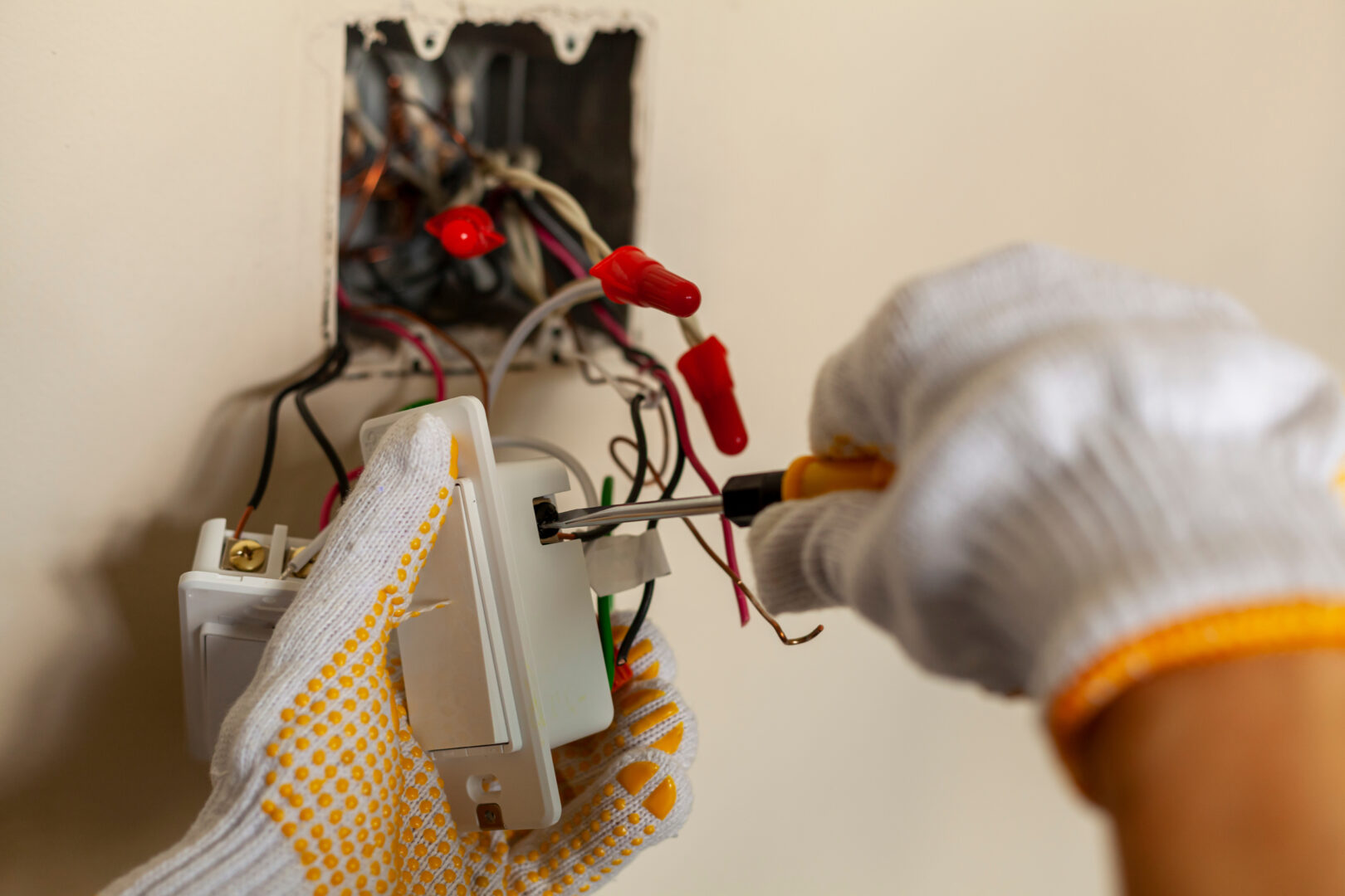 Electrician Services: An electrician is replacing a wall switch A DIY project concept